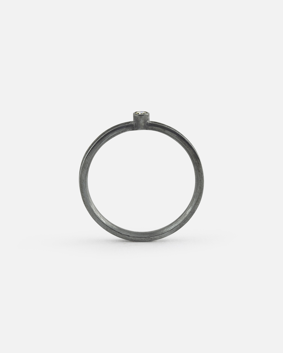 black silver ring with round diamond